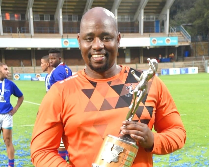 Rannoa Dan Ntseke poses with a Women’s Varsity Cup Rugby Trophy