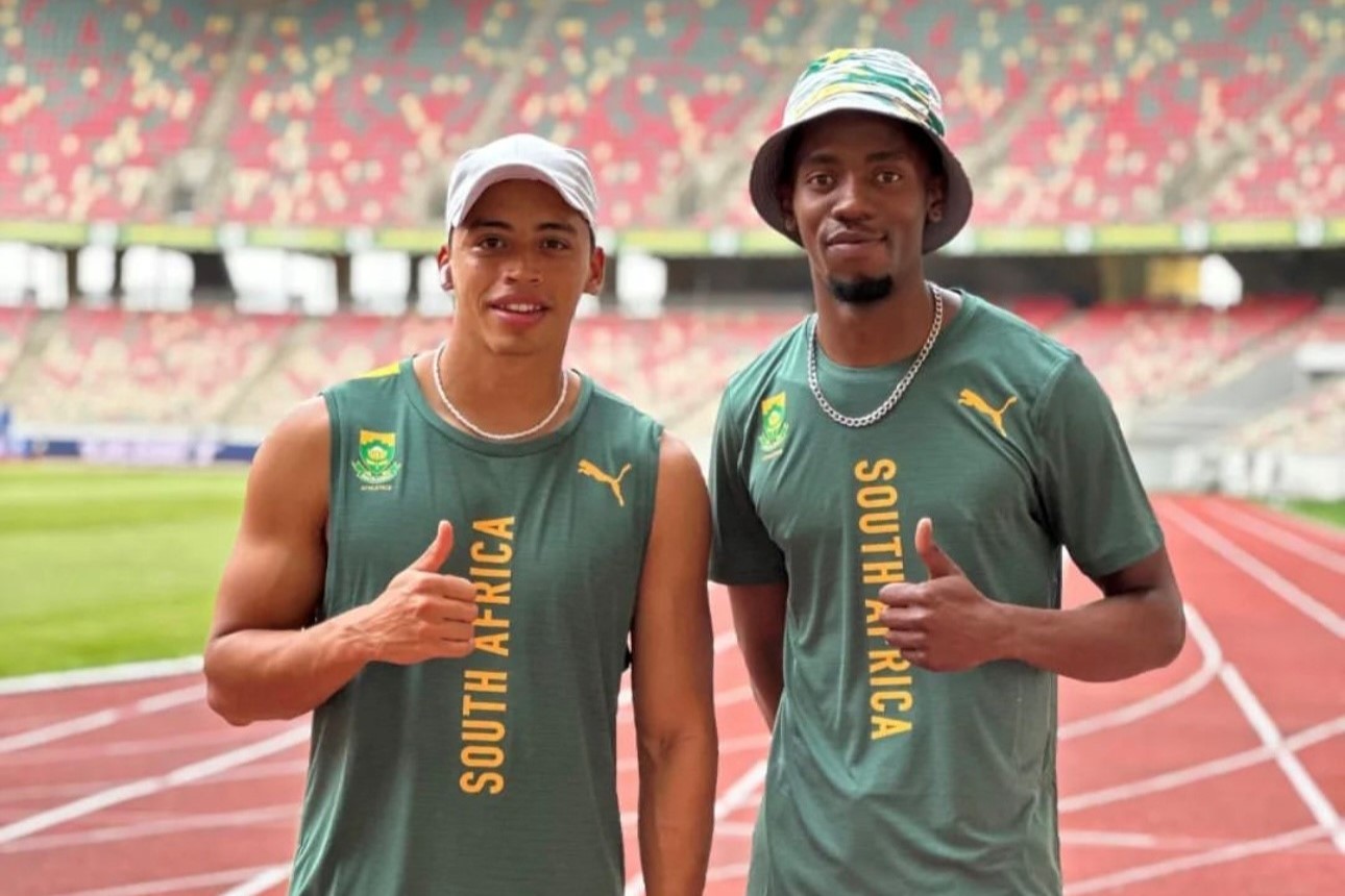 Two boys wearing green with a touch of gold clothes for the South African Athletic team