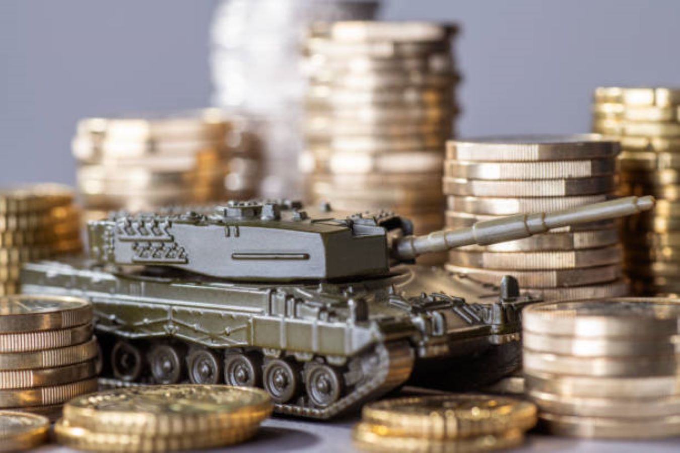 military tank toy surrounded by gold coins